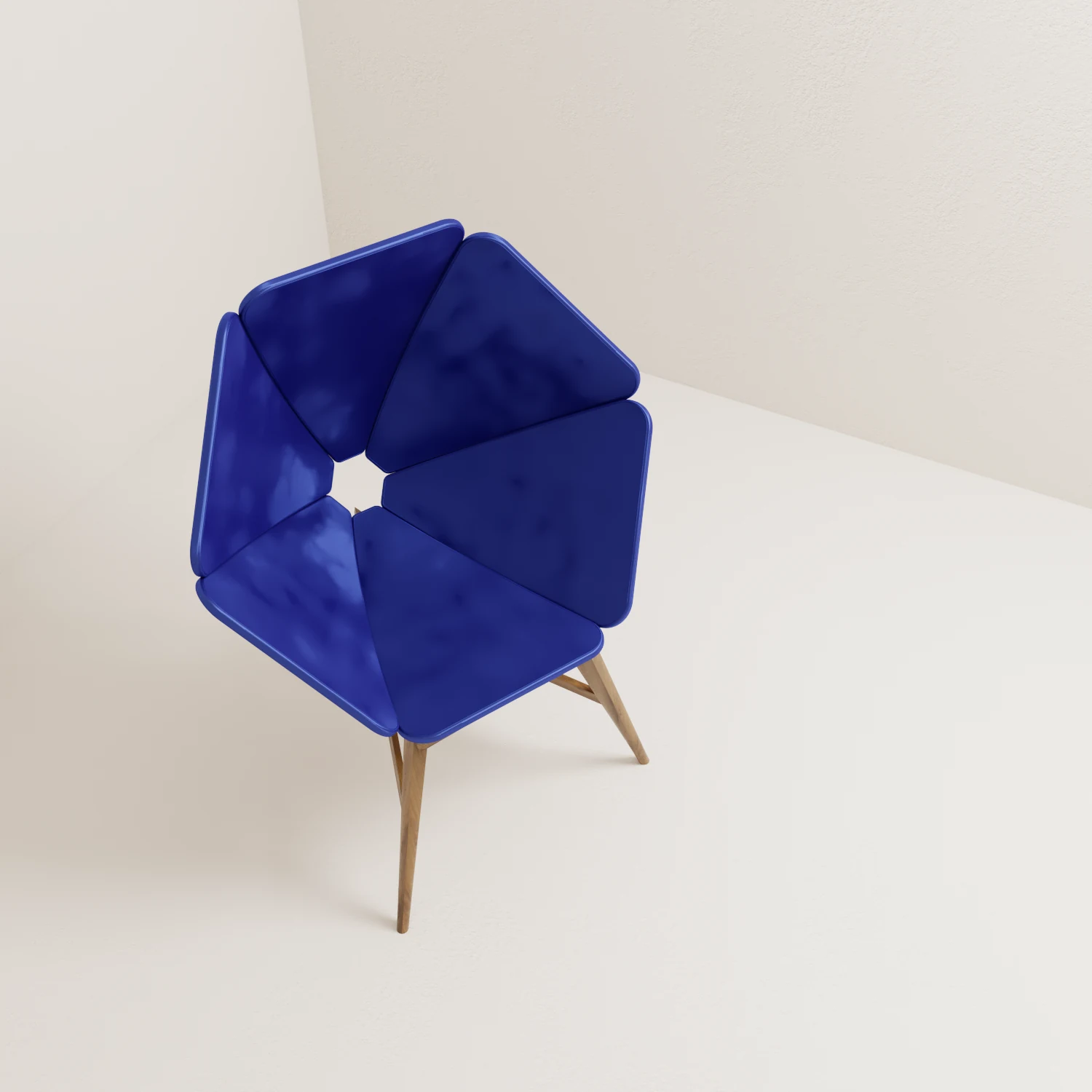 Geometric Petal Lounge Chair with cobalt-blue faceted panels and a timber base, viewed from above.